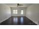 Well-lit living room featuring a ceiling fan, hardwood floors and access to the patio at 16425 Grapperhall Dr, Huntersville, NC 28078