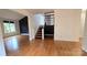 Bright living room showcasing hardwood floors and natural light, complemented by stylish decor at 16425 Grapperhall Dr, Huntersville, NC 28078