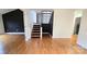 Spacious living room featuring hardwood floors, a staircase and ample natural light at 16425 Grapperhall Dr, Huntersville, NC 28078