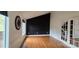 Open living room featuring black accent wall, hardwood flooring and lots of natural light at 16425 Grapperhall Dr, Huntersville, NC 28078