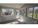 Bright sunroom with multiple windows and a glass exterior door at 16425 Grapperhall Dr, Huntersville, NC 28078