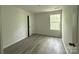 Cozy bedroom with wood-look floors, bright window and neutral paint at 168 Wildwood Loop, Statesville, NC 28625