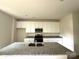 Bright, eat-in kitchen featuring a large island, granite counters, and white cabinets at 168 Wildwood Loop, Statesville, NC 28625