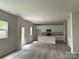 Open-concept kitchen featuring an eat-in island, stainless appliances, and white cabinets at 168 Wildwood Loop, Statesville, NC 28625