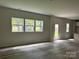 Unfurnished living room featuring wood-look flooring and a wall of windows at 168 Wildwood Loop, Statesville, NC 28625