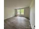 Spacious living room with wood floors and lots of natural light from the two windows at 168 Wildwood Loop, Statesville, NC 28625