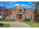 Charming brick home with manicured lawn, front porch, and circular driveway at 18912 Peninsula Point Dr, Cornelius, NC 28031