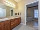 A well-lit bathroom features a double sink vanity and a peek into the soaking tub area, offering comfort at 25040 Timberlake Dr, Tega Cay, SC 29708