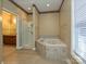 This elegant bathroom provides a soaking tub and separate shower, offering comfort and convenience at 25040 Timberlake Dr, Tega Cay, SC 29708