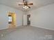 A spacious bedroom with neutral carpet offers a serene retreat, enhanced by natural light and ceiling fan at 25040 Timberlake Dr, Tega Cay, SC 29708