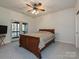 Cozy bedroom with a ceiling fan, carpet, and access to an outdoor balcony at 25040 Timberlake Dr, Tega Cay, SC 29708