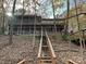 Exterior view of a home with a wooden stairway and multiple decks surrounded by trees at 25040 Timberlake Dr, Tega Cay, SC 29708