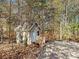 View of an outbuilding with outdoor seating nestled in a wooded setting at 25040 Timberlake Dr, Tega Cay, SC 29708
