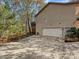 View of the side of the house showcasing garage, decks, and surrounding landscape at 25040 Timberlake Dr, Tega Cay, SC 29708