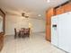 Kitchen with tile floor and wooden cabinets connects seamlessly to dining area, with a large fridge at 25040 Timberlake Dr, Tega Cay, SC 29708