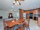 A charming kitchen with a wooden dining table and cabinets offers both functionality and a cozy dining space at 25040 Timberlake Dr, Tega Cay, SC 29708