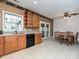 Kitchen with tile floor and wooden cabinets connects seamlessly to dining area with wooden dining table at 25040 Timberlake Dr, Tega Cay, SC 29708