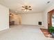Bright living room featuring neutral carpet and a decorative fireplace at 25040 Timberlake Dr, Tega Cay, SC 29708