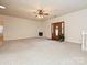 Bright living room featuring neutral carpet and a decorative fireplace at 25040 Timberlake Dr, Tega Cay, SC 29708