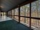 A screened porch offers views of the wooded backyard, showcasing nature views at 25040 Timberlake Dr, Tega Cay, SC 29708