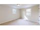 Neutral-toned bedroom with carpet, white trim, and natural light from windows, offering a serene atmosphere at 665 Firecrest Se St, Concord, NC 28025