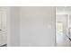 Hallway leading to the kitchen with stainless steel appliances, bright windows, and hardwood flooring at 109 Obadiah Ct, Troutman, NC 28115