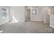 Bright loft area featuring plush carpeting, a window, and a view of another room at 109 Obadiah Ct, Troutman, NC 28115