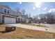 Street view of newly built homes featuring attached garages and manicured lawns at 109 Obadiah Ct, Troutman, NC 28115