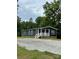 Charming one-story home with navy blue siding, white trim, and a gravel driveway surrounded by lush trees at 1100 Turkey Creek Ridge Rd, York, SC 29745