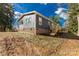 Dark gray siding, brick foundation, and a wooden deck at 1100 Turkey Creek Ridge Rd, York, SC 29745