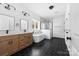 Stylish bathroom featuring a double vanity, soaking tub, and glass-enclosed shower on hexagon tile floor at 1300 Eddie St, Gastonia, NC 28054