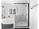 Bright bathroom featuring a modern glass enclosed shower, a soaking tub, and black hexagonal tile floor at 1300 Eddie St, Gastonia, NC 28054