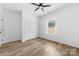 Neutrally painted bedroom featuring wood floors, double door closet, ceiling fan, and a window at 1300 Eddie St, Gastonia, NC 28054