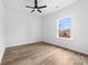 Bright bedroom with wood floors, ceiling fan, and a window offering a pleasant outdoor view at 1300 Eddie St, Gastonia, NC 28054