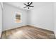 Clean bedroom with wood floors, a ceiling fan, and natural light from the large window at 1300 Eddie St, Gastonia, NC 28054