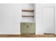 Stylish built-in cabinet with open shelves and white herringbone backsplash next to a door at 1300 Eddie St, Gastonia, NC 28054