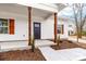 Inviting entryway with wooden pillars, enhanced by fresh landscaping and a well-lit porch area at 1300 Eddie St, Gastonia, NC 28054
