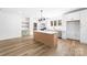Open kitchen with white cabinetry, island with seating, and stainless steel appliances at 1300 Eddie St, Gastonia, NC 28054