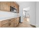 Charming kitchen featuring wood cabinetry, stainless steel microwave, quartz counters and beverage cooler at 1300 Eddie St, Gastonia, NC 28054