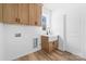 Functional laundry room with wood cabinets, a utility sink, and washer/dryer hookups at 1300 Eddie St, Gastonia, NC 28054