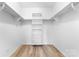 Well-organized walk-in closet with built-in shelving and ample storage space on wood floor at 1300 Eddie St, Gastonia, NC 28054