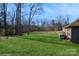 Spacious backyard with grassy lawn, mature trees, and a shed at 1808 Wilton Gate Dr, Charlotte, NC 28262