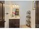 Clean bathroom with dark vanity and decorative shelving at 1808 Wilton Gate Dr, Charlotte, NC 28262