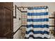 Clean bathroom with tiled shower and blue and white striped curtain at 1808 Wilton Gate Dr, Charlotte, NC 28262