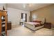 Main bedroom with plush bed, large window, and decorative chandelier at 1808 Wilton Gate Dr, Charlotte, NC 28262
