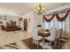 Open dining area with a wood table and chairs near the living room at 1808 Wilton Gate Dr, Charlotte, NC 28262