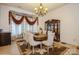 Elegant dining room with a large table, chandelier, and decorative curtains at 1808 Wilton Gate Dr, Charlotte, NC 28262
