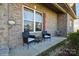 Inviting front porch with two wicker chairs and side table at 1808 Wilton Gate Dr, Charlotte, NC 28262
