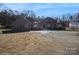 Brick house with a large driveway and mature trees at 1808 Wilton Gate Dr, Charlotte, NC 28262