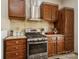Bright kitchen features wood cabinets, tiled counters, and stainless steel appliances at 1808 Wilton Gate Dr, Charlotte, NC 28262